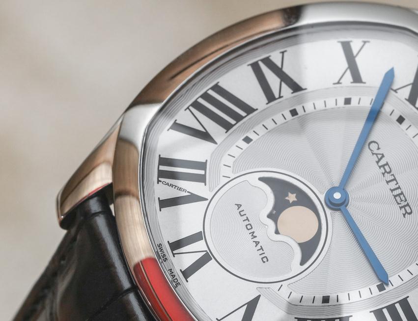 The silver-plated dials fake Drive De Cartier WGNM0008 watches have black Roman numerals, blue hands and moon phases at 6 o'clock. 